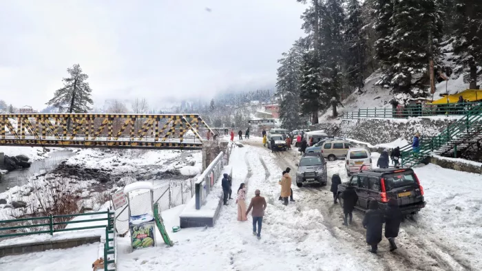 कश्मीर के गुलमर्ग से सटे द्रंग क्षेत्र में बर्फबारी के बीच पर्यटकों का जमावड़ा।