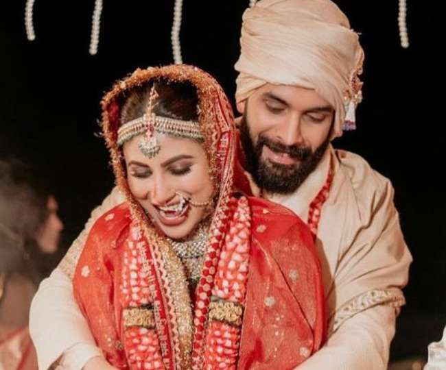 mouni roy spotted at airport with husband suraj nambiar she looks gorgeous in red sari and sindoor